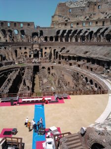 A crew works to partially rebuild the stage in the Colosseum